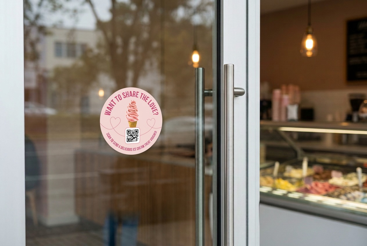 Round GiftPop QR sticker on a shop's glass door